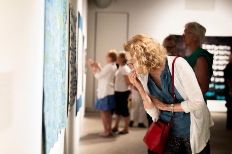 A guest looks at a quilt created by Chawne Kimber, professor of mathematics