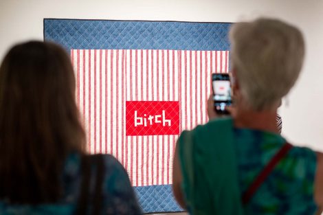 Someone takes a cell phone photo of a quilt created by Chawne Kimber, professor of mathematics