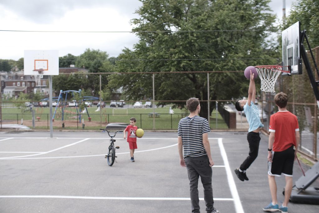 Camper goes up for a big dunk on a basketball net.