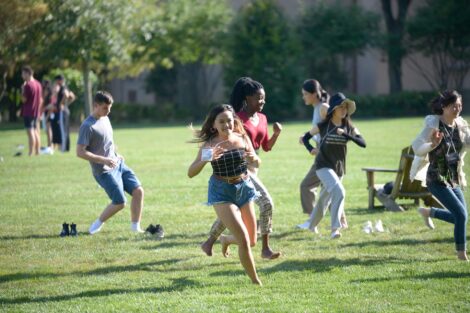 international student runs on quad