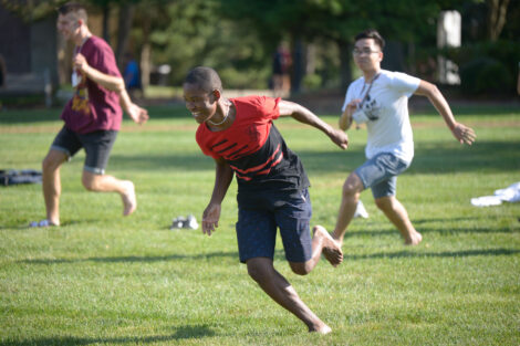 international student runs on quad