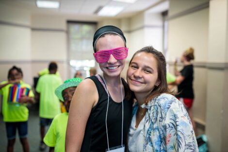 Two POSPers stand together and smile