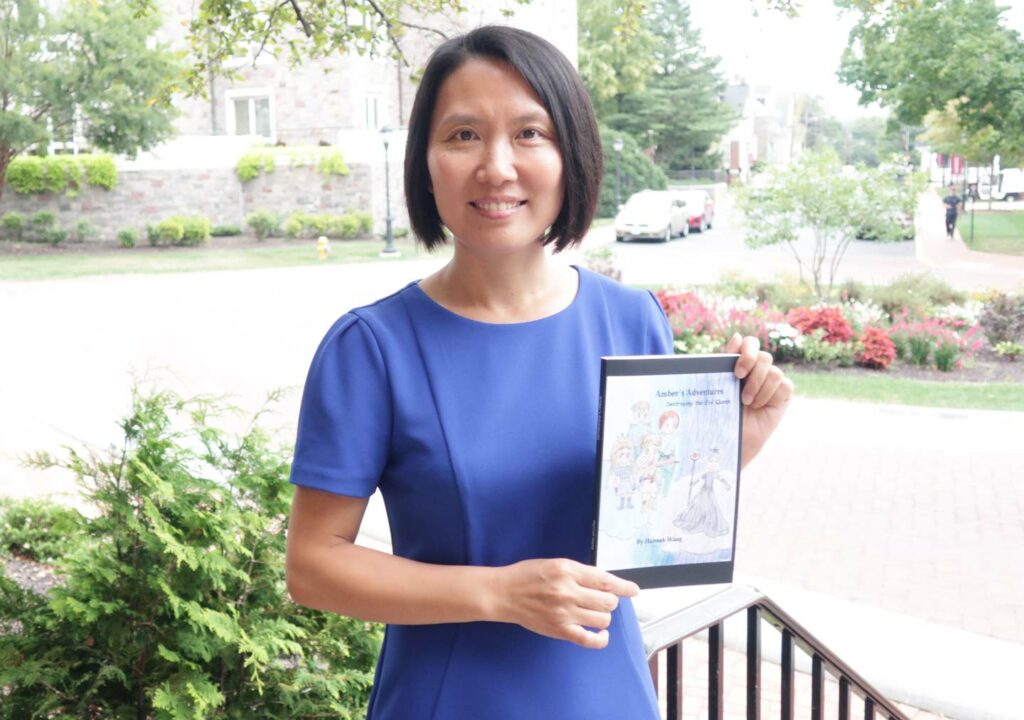 Han Luo holds a book that her daughter Hannah wrote and published.