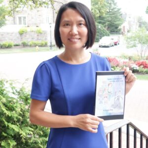 Han Luo holds a book that her daughter Hannah wrote and published.
