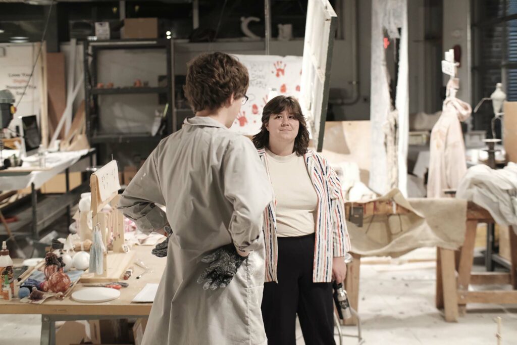 Kim Altomare speaks with a student about his work