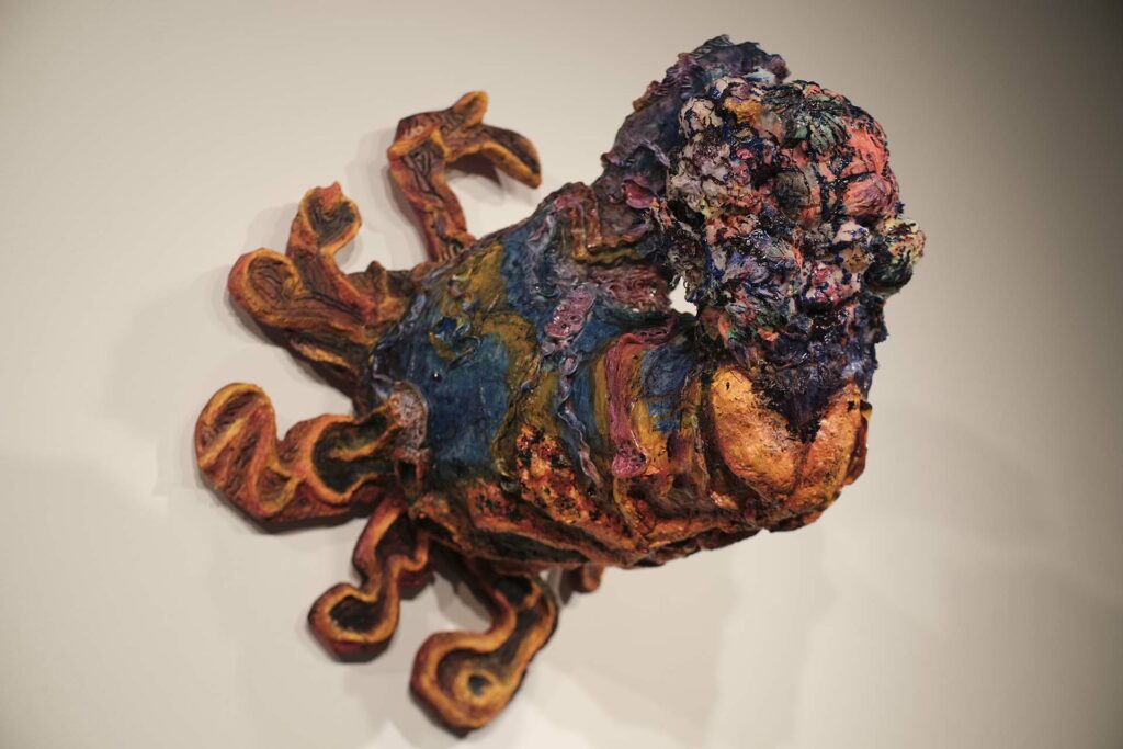 Painting and sculpture combine as piece rises off the wall like an octopus