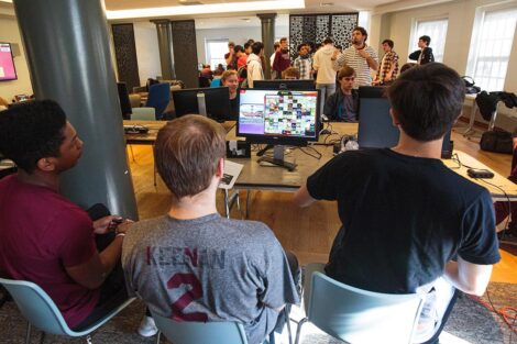 A group of students from Lafayette and Lehigh Esports clubs sit together and play video games.