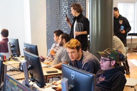 A group of students from Lafayette and Lehigh Esports clubs sit together and play video games.