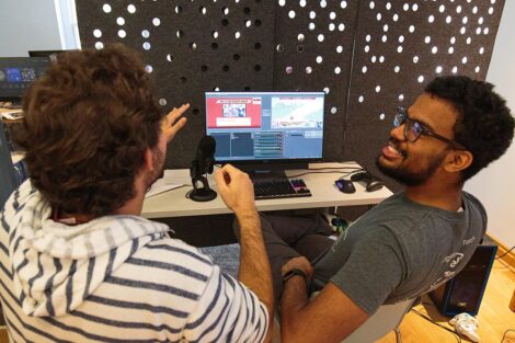 A group of students from Lafayette and Lehigh Esports clubs sit together and play video games.