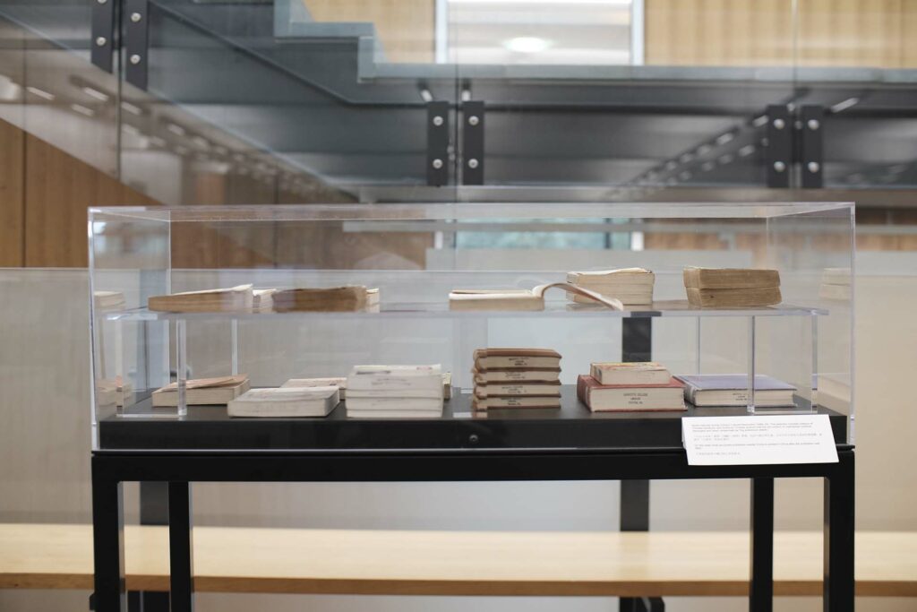 Xiaoze Xie's work on display in cases showing two levels of books