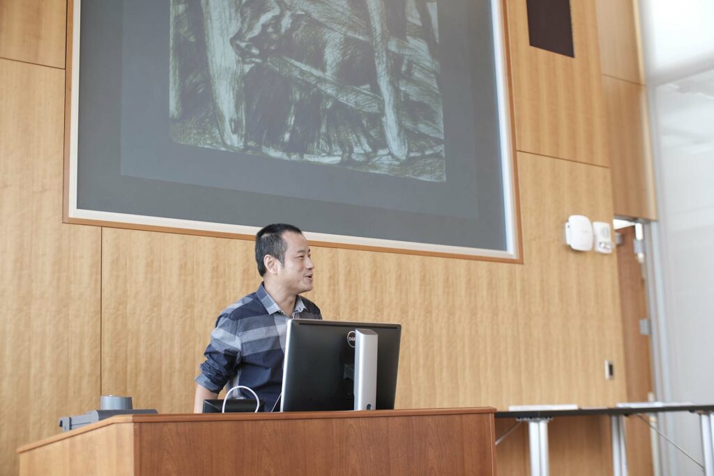 Xiaoze Xie speaks at podium