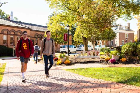 students set against the beautiful oranges and yellows of fall scenery at Lafayette