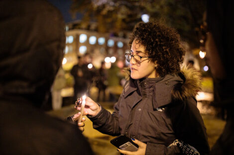 students light candles as part of the take back the night vigil