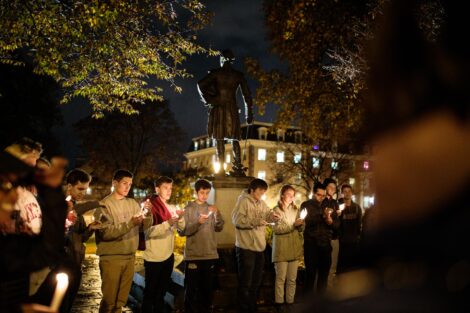 students light candles as part of the take back the night vigil