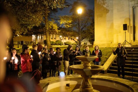 students light candles as part of the take back the night vigil