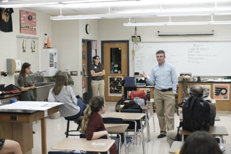 Turner Construction adviser speaks with ACE students after presentations.