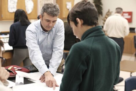 Adviser help ACE students as they prepare final presentations