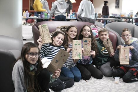 A group of fourth graders pose with their decorated bags