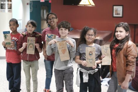 A group of fourth graders pose with their decorated bags