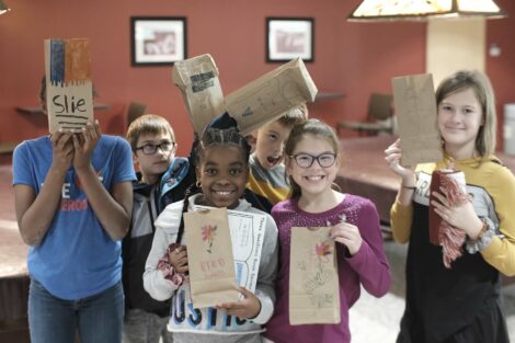 A group of fourth graders pose with their decorated bags