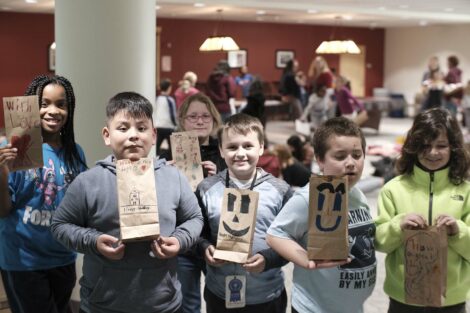 A group of fourth graders pose with their decorated bags