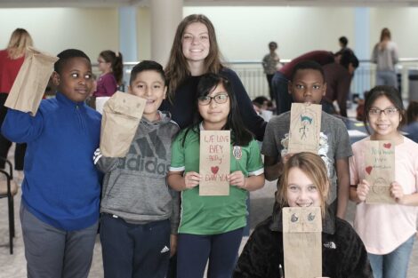 A group of fourth graders pose with their decorated bags