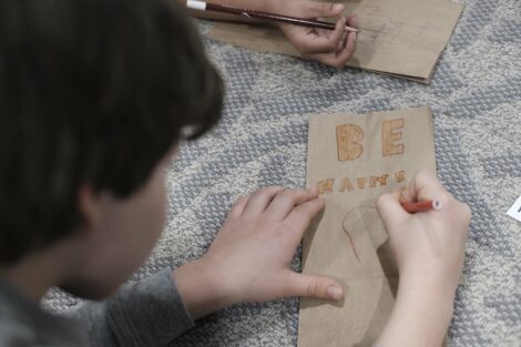 Fourth grade student decorates a bag