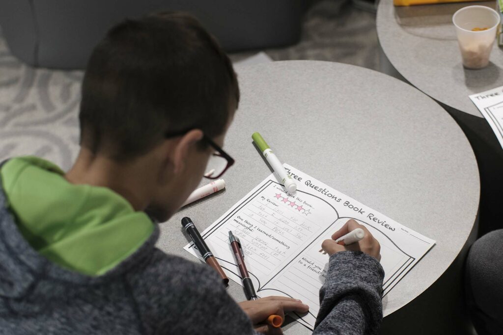 Fourth grade student completes his worksheet about the story
