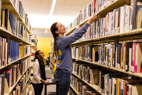 Ella Goodwin '21, a student worker in Skillman, measures the unused bookshelf space in order to make room for new knowledge.
