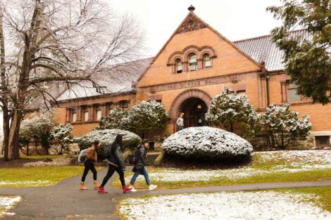 students walk in front of van wickle