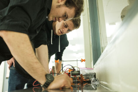 students build robot cars in the maker space of acopian