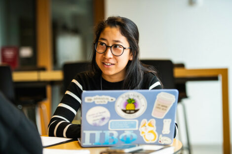 A student works with a laptop on the first day of spring semester.