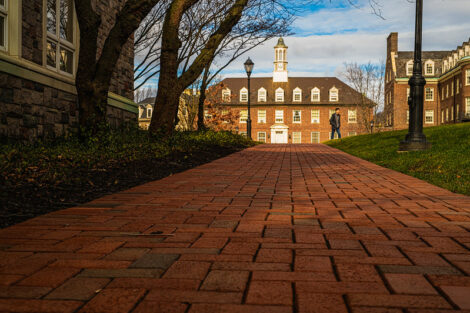 A brick walkway behind the Farinon Center with one student in the distance on the first day of spring semester