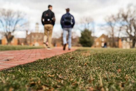 Two students walk on the Quad on the first day of spring semester.