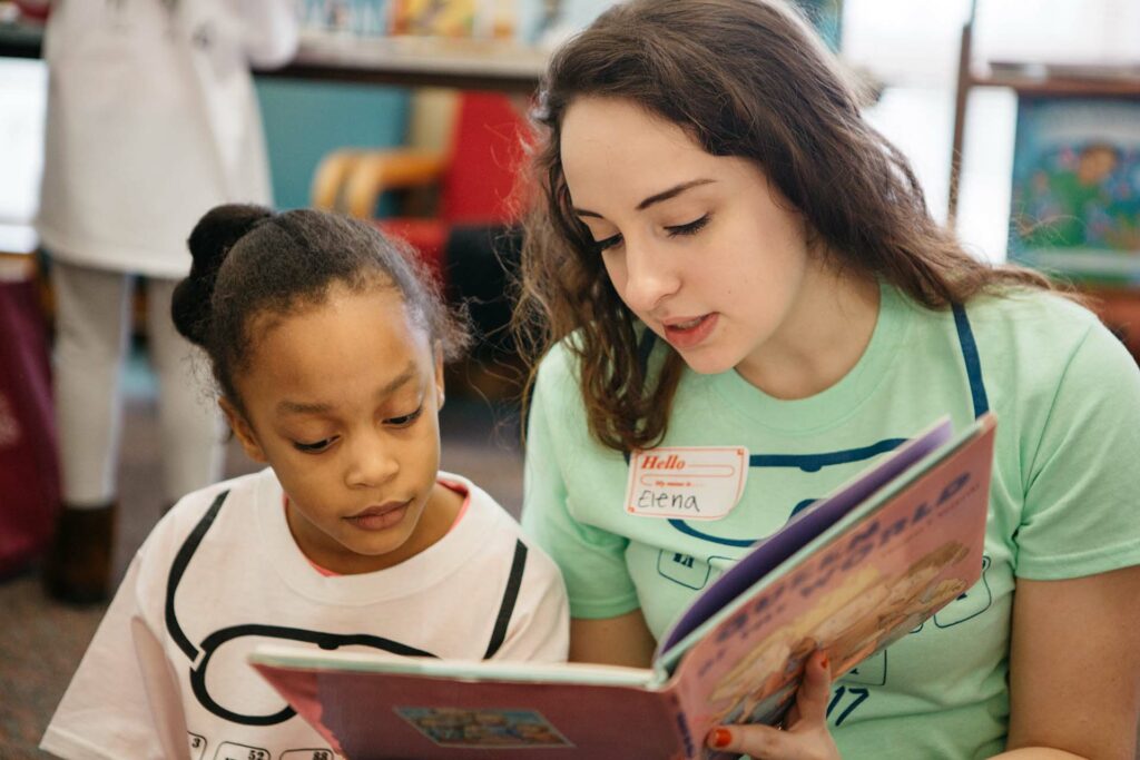 Landis Center student volunteer reads to an area elementary student