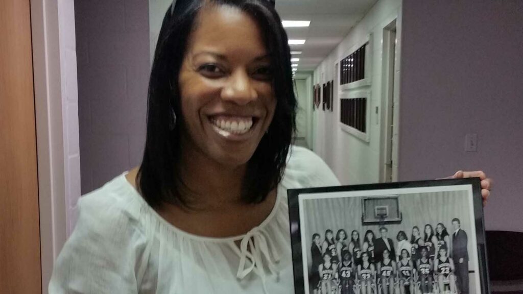 Kareema J. Gray, Ph.D., ’94 with a photo of her women's basketball teammates. "Being a student-athlete at Lafayette taught me discipline, and how to organize and prioritize," she says.