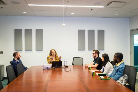 Three student externs speak with two alumni hosts