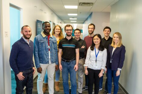 Alumni gather with three externs for photo