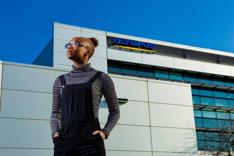 Student extern stands outside Olympus headquarters