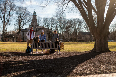Students enjoying an unseasonably warm winter day on the quad, with Colton Chapel in the background.