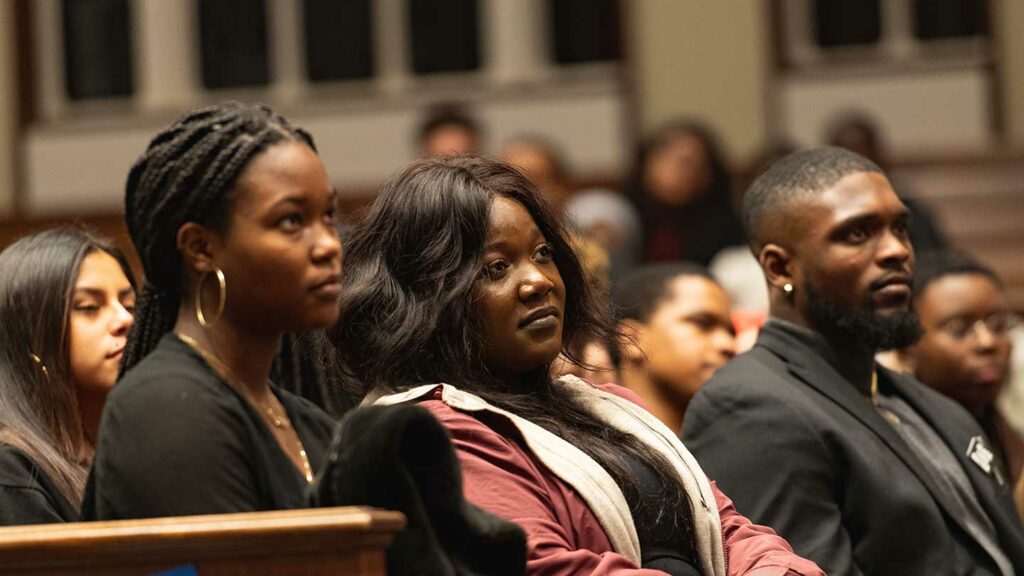 Students listen to Yusef Salaam speak in Colton Chapel