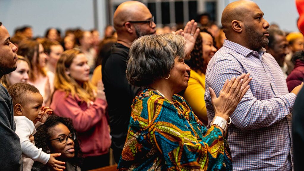An audience in Colton Chapel gives Yusef Salaam a standing ovation.