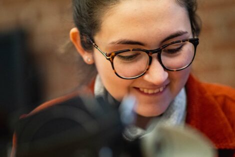Student smiles as she works