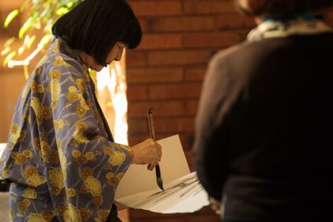 calligraphy master Shuho Kondo uses brush on paper