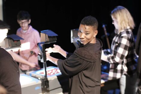 Manual Cinema performer demonstrates how to use hands with the projector