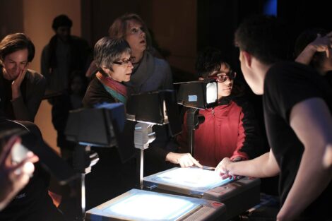 Audience members marvel at how the projectors work
