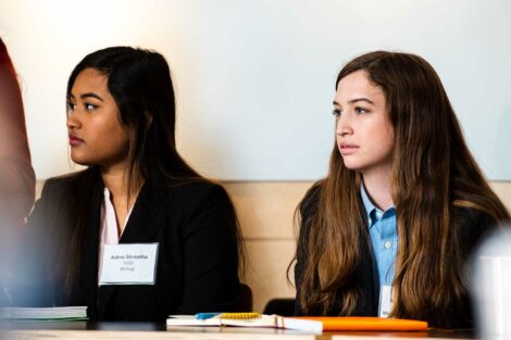 Two students listen intently
