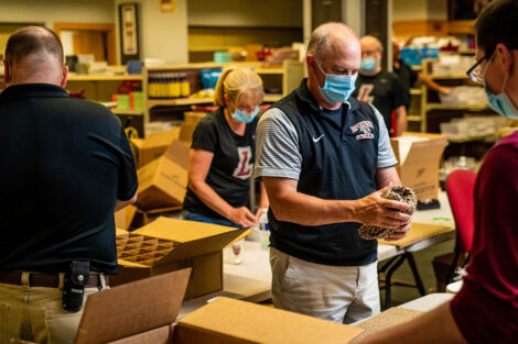 staff put items in boxes for Class of 2020 grads