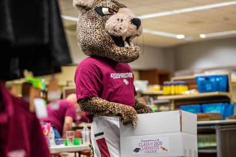 leopard holding senior box in bookstore