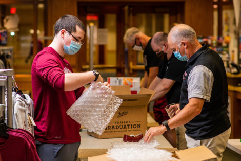 staff put items in boxes for Class of 2020 grads